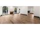 Open-concept living room featuring hardwood floors, fireplace, and arched windows at 650 Moores Mill Nw Rd # 1, Atlanta, GA 30327