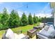 Beautiful backyard with a well-maintained lawn, string lights, and comfortable outdoor furniture, perfect for entertaining at 1316 Willamette Way, Marietta, GA 30008