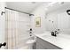 Modern bathroom featuring a shower-tub combo, sleek vanity, and matte black fixtures at 1316 Willamette Way, Marietta, GA 30008
