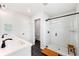 Modern bathroom features a double sink vanity, black fixtures, and a glass-enclosed shower with subway tile at 1316 Willamette Way, Marietta, GA 30008