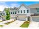 Charming townhome exterior with a well-manicured lawn and a two-car garage, showcasing modern design at 1316 Willamette Way, Marietta, GA 30008