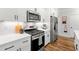 Close-up of the kitchen with stainless steel appliances, white cabinetry, and modern countertops at 1316 Willamette Way, Marietta, GA 30008