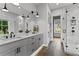 Bright bathroom featuring double sinks, a walk-in shower, and a soaking tub at 185 Central Ave, Fayetteville, GA 30214