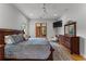 Spacious bedroom with a king-size bed, ceiling fan, a TV, and natural light at 185 Central Ave, Fayetteville, GA 30214