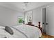 Bedroom features a wooden bed frame, ensuite bathroom, and neutral walls at 185 Central Ave, Fayetteville, GA 30214