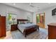 Comfortable bedroom featuring a king-size bed, ceiling fan, and access to a private outdoor space at 185 Central Ave, Fayetteville, GA 30214