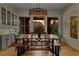 Elegant dining room featuring a wooden table, stylish light fixture, and ample natural light at 185 Central Ave, Fayetteville, GA 30214