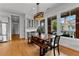 Bright dining room with a wood table and bench seating, plus a contemporary light fixture overhead at 185 Central Ave, Fayetteville, GA 30214