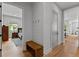 Bright entryway with shiplap accent wall, wood bench, and hardwood floors leading to the bedroom at 185 Central Ave, Fayetteville, GA 30214
