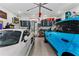 Well-organized garage featuring two luxury vehicles, ample storage cabinets, and bright overhead lighting at 185 Central Ave, Fayetteville, GA 30214