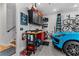 Organized garage with epoxy flooring, equipped with tool benches, storage solutions, and sports cars at 185 Central Ave, Fayetteville, GA 30214