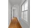 Bright hallway featuring hardwood floors and a large window providing natural light and a welcoming ambiance at 185 Central Ave, Fayetteville, GA 30214