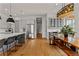 Modern kitchen featuring stainless steel appliances, an island with barstool seating, and a wooden dining table at 185 Central Ave, Fayetteville, GA 30214