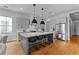 Open kitchen with a large center island with bar stool seating and stainless steel appliances at 185 Central Ave, Fayetteville, GA 30214