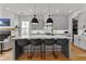 Modern kitchen features a center island with seating, white subway tile backsplash, and stainless appliances at 185 Central Ave, Fayetteville, GA 30214
