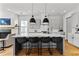 Stylish kitchen featuring a large center island with bar stool seating, grey cabinets, and pendant lighting at 185 Central Ave, Fayetteville, GA 30214
