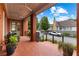 Charming front porch with brick detail, ceiling fans, and comfortable outdoor furniture at 185 Central Ave, Fayetteville, GA 30214