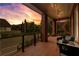 Inviting front porch with brick columns, ceiling fan, and ample seating at 185 Central Ave, Fayetteville, GA 30214