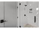 Modern shower features subway tile, mosaic flooring, and matte black fixtures at 185 Central Ave, Fayetteville, GA 30214