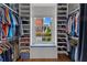 Organized walk-in closet with custom shelving and a window with a built-in seat at 185 Central Ave, Fayetteville, GA 30214