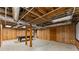 Large basement with exposed ceiling, wood paneled walls, and a billiards table at 220 Hollyridge Dr, Roswell, GA 30076