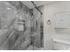 Contemporary bathroom with glass-enclosed shower, marble-like tile, and built-in niche at 220 Hollyridge Dr, Roswell, GA 30076