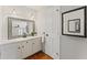 Bathroom with a white vanity, decorative mirrors, and ample counter space at 220 Hollyridge Dr, Roswell, GA 30076