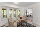 Cozy breakfast nook with a table, seating for two, and access to screened porch and living room at 220 Hollyridge Dr, Roswell, GA 30076