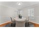 Bright dining room with hardwood floors, crown molding, and plantation shutters at 220 Hollyridge Dr, Roswell, GA 30076
