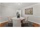 Elegant dining room with hardwood floors, crown molding, and seating for four around a round table at 220 Hollyridge Dr, Roswell, GA 30076