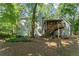 Rear exterior view of two-story house with screened porch and wooden stairs leading from the second floor at 220 Hollyridge Dr, Roswell, GA 30076