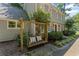 A wooden porch swing with pillows is the perfect spot to relax and enjoy the outdoors at 220 Hollyridge Dr, Roswell, GA 30076