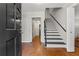 Warm foyer with hardwood floors, staircase, and neutral paint offering a welcoming entrance at 220 Hollyridge Dr, Roswell, GA 30076