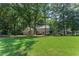 Two-story house with a large front yard and mature trees at 220 Hollyridge Dr, Roswell, GA 30076