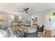 A well-designed living room has a ceiling fan, a view into the kitchen, and access to the porch at 220 Hollyridge Dr, Roswell, GA 30076