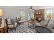 A well-lit living room showcases a stone fireplace, ceiling fan, and an open floor plan at 220 Hollyridge Dr, Roswell, GA 30076
