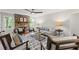 Living room featuring a stone fireplace, ceiling fan, and plenty of seating options at 220 Hollyridge Dr, Roswell, GA 30076