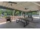 Outdoor picnic area with multiple tables, grills, and ceiling fans at 220 Hollyridge Dr, Roswell, GA 30076
