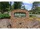 Stone community sign for Hollyberry, with lush landscaping at 220 Hollyridge Dr, Roswell, GA 30076