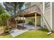 Cozy back patio beneath a wooden deck, featuring a concrete floor and access to the backyard at 2873 Hilton Nw Cir, Kennesaw, GA 30152