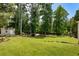 Expansive backyard with a shed, mature trees, and garden beds at 2873 Hilton Nw Cir, Kennesaw, GA 30152