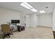 Finished basement area with neutral tiling, drop ceiling and bright lighting at 2873 Hilton Nw Cir, Kennesaw, GA 30152