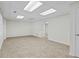 Finished basement features neutral colored tile flooring, white walls and trim at 2873 Hilton Nw Cir, Kennesaw, GA 30152