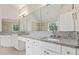 Bathroom featuring double sinks with granite countertops and a large framed mirror at 2873 Hilton Nw Cir, Kennesaw, GA 30152