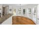 Sunlit breakfast nook with granite countertop bar, hardwood floors, and lots of windows overlooking the backyard at 2873 Hilton Nw Cir, Kennesaw, GA 30152