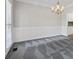 Dining room with a stylish carpet, chandelier, and paneled wall adding charm to this home at 2873 Hilton Nw Cir, Kennesaw, GA 30152