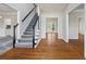 Bright foyer featuring hardwood floors, staircase with black banister, and views into other rooms at 2873 Hilton Nw Cir, Kennesaw, GA 30152