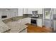 Bright kitchen features granite counters, stainless steel appliances, and hardwood floors at 2873 Hilton Nw Cir, Kennesaw, GA 30152