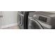 Modern laundry room featuring gray front loading washer and dryer at 2873 Hilton Nw Cir, Kennesaw, GA 30152