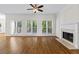 Spacious living room with hardwood floors, a fireplace, large windows, and doors to the outside deck at 2873 Hilton Nw Cir, Kennesaw, GA 30152